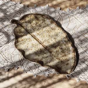 Ręcznie wykonany talerz ceramiczny z odciśniętym na powierzchni liściem